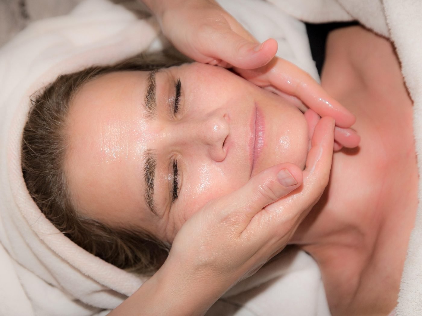 Client relaxing during a facial treatment