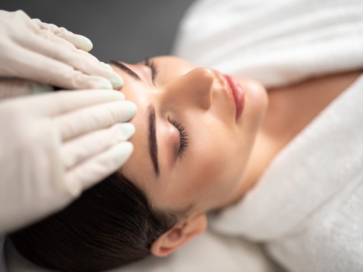 Therapist giving a client a facial treatment